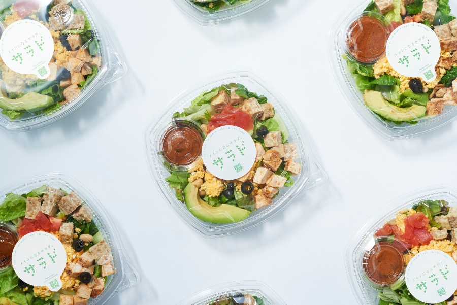 sealed lunch salad boxes with croutons, avocado and dipping sauce